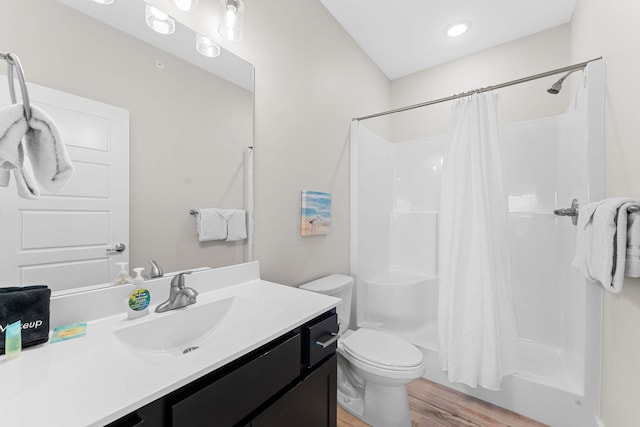 bathroom featuring vanity, toilet, hardwood / wood-style flooring, and a shower with shower curtain