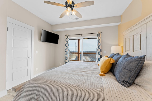 bedroom featuring ceiling fan, light hardwood / wood-style floors, and access to outside