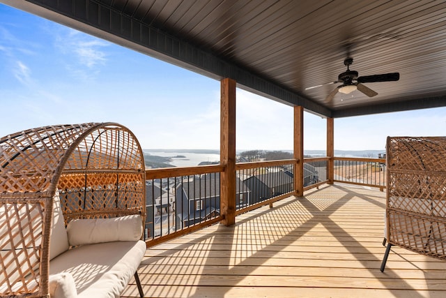 wooden terrace featuring an outdoor living space, a water view, and ceiling fan