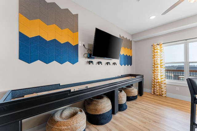 playroom with ceiling fan and hardwood / wood-style floors