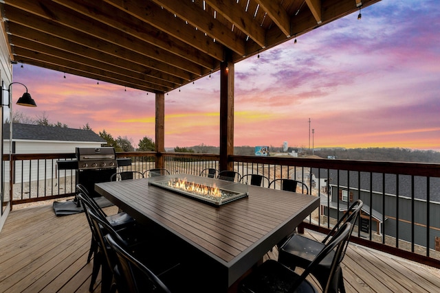 deck at dusk featuring area for grilling