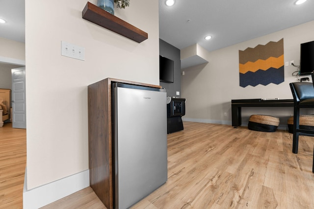 kitchen featuring stainless steel refrigerator and light hardwood / wood-style flooring