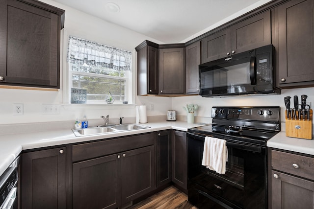 kitchen with light hardwood / wood-style flooring, black appliances, sink, and dark brown cabinetry