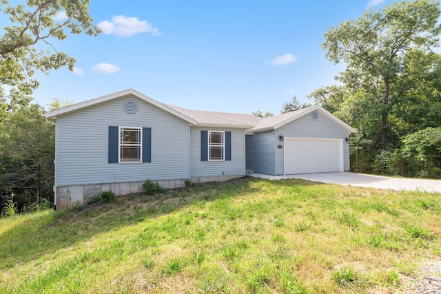 single story home featuring a garage and a front yard