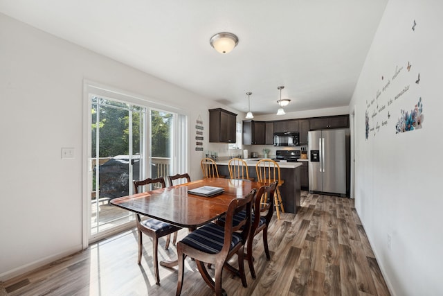 dining space featuring wood-type flooring