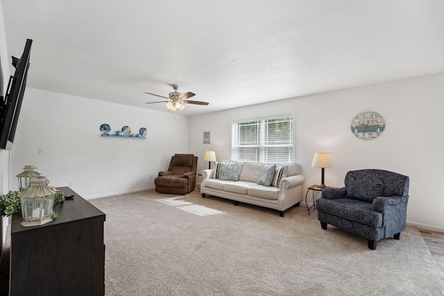 living room featuring light carpet and ceiling fan