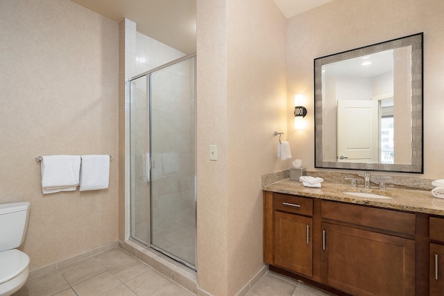 bathroom featuring vanity, tile patterned flooring, toilet, and a shower with shower door