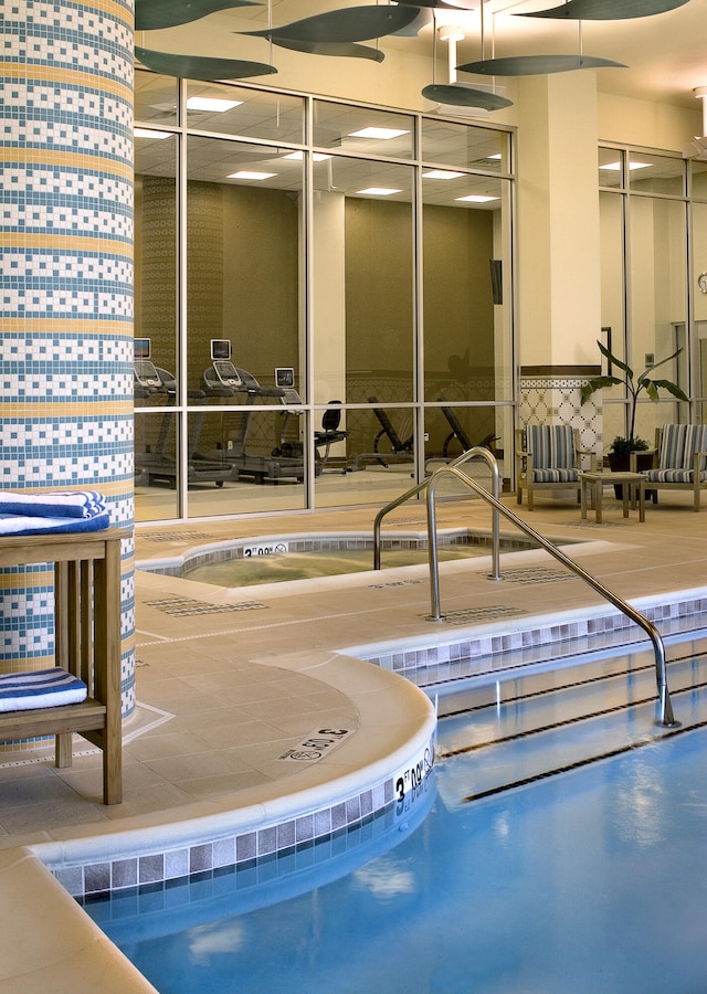 view of swimming pool with an indoor hot tub