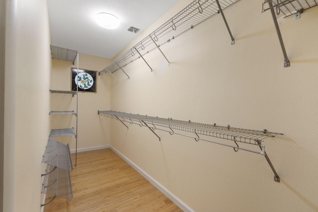 spacious closet featuring light wood-style flooring