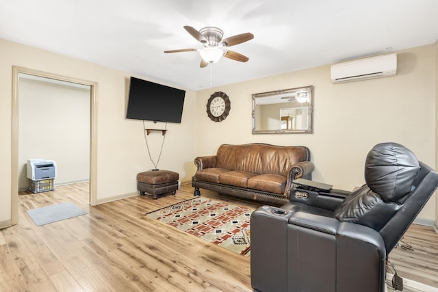 living area with a wall mounted AC, wood finished floors, baseboards, and ceiling fan