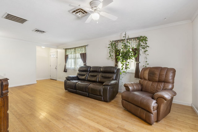 living area with visible vents, light wood-style floors, ceiling fan, and crown molding