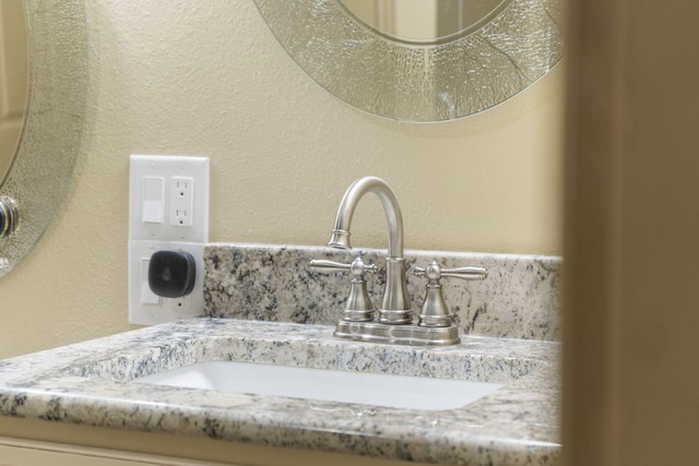 interior details featuring a textured wall and a sink