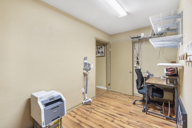 office featuring light wood-type flooring and baseboards