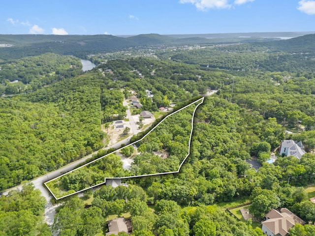 drone / aerial view with a wooded view