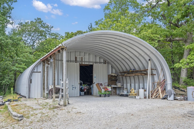view of car parking with an outbuilding and a garage