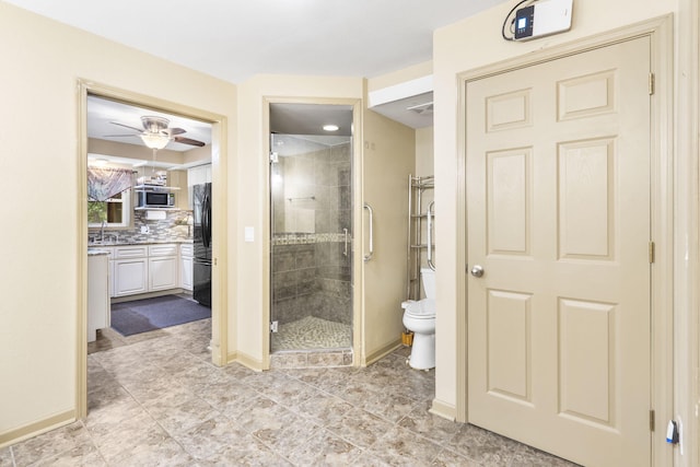 bathroom featuring ceiling fan, walk in shower, vanity, toilet, and backsplash