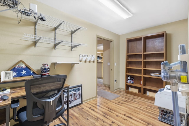 office area with baseboards and wood finished floors