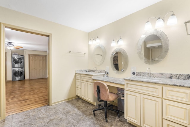 bathroom featuring stacked washer and dryer, hardwood / wood-style flooring, vanity, and ceiling fan