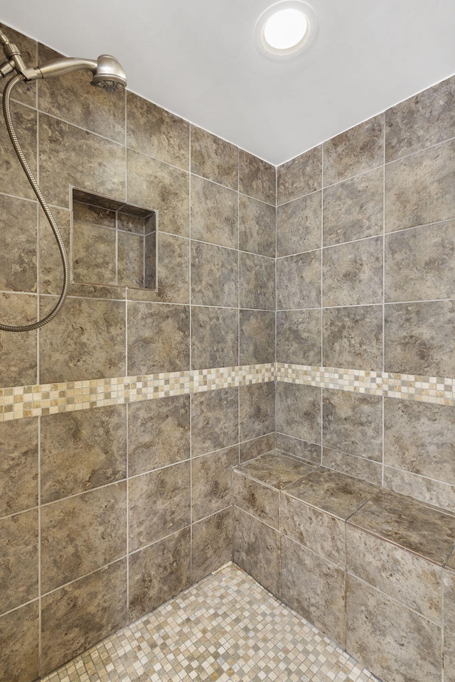 bathroom with tiled shower