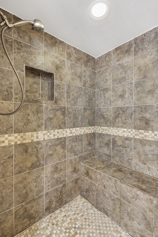 bathroom with a tile shower