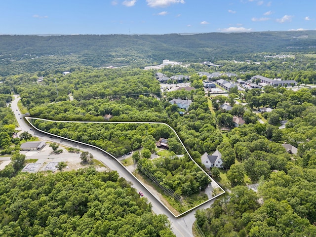 birds eye view of property featuring a view of trees