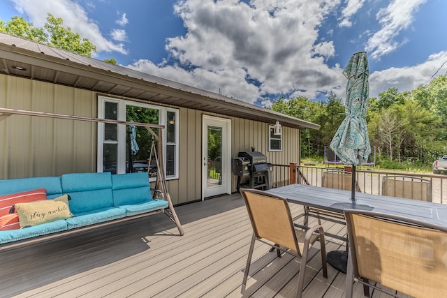 wooden deck featuring outdoor lounge area and a grill