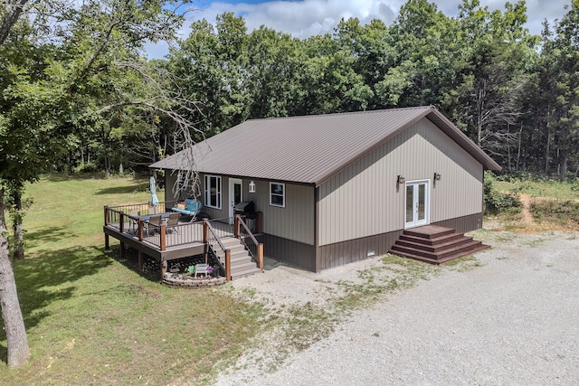 7084 Logan Rd, Hartville, MO 65667 - view of front of home with metal roof, french doors, a front yard, and a deck