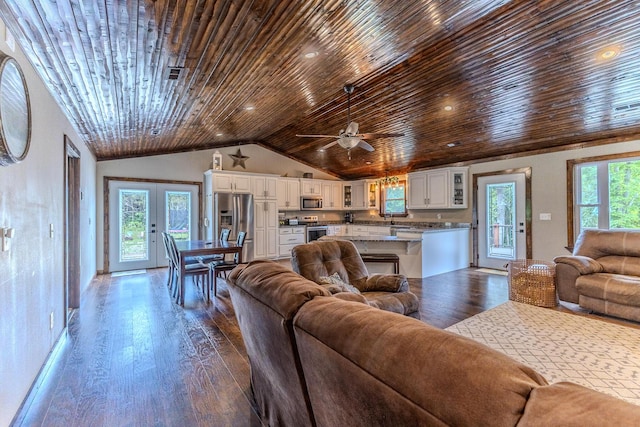 7084 Logan Rd, Hartville, MO 65667 - living area with dark wood finished floors, lofted ceiling, french doors, wood ceiling, and ceiling fan