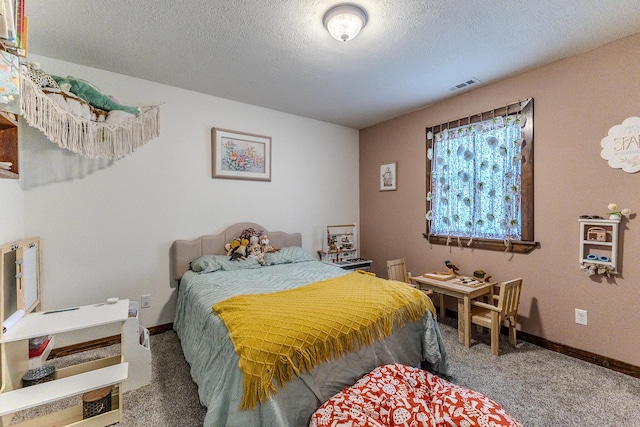 bedroom featuring carpet flooring and a textured ceiling