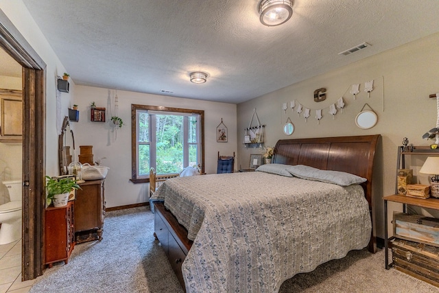 bedroom featuring carpet and a textured ceiling