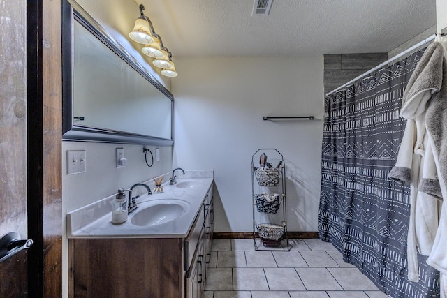 7084 Logan Rd, Hartville, MO 65667 - bathroom featuring tile patterned floors, visible vents, a sink, and a textured ceiling