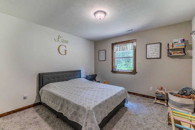 bedroom featuring light colored carpet and a textured ceiling