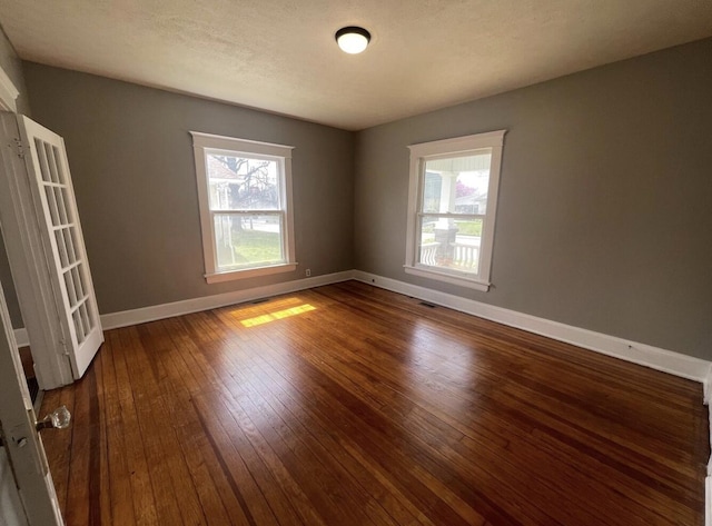 1230 N Grant Ave, Springfield, MO 65802 - spare room featuring visible vents, baseboards, and wood-type flooring