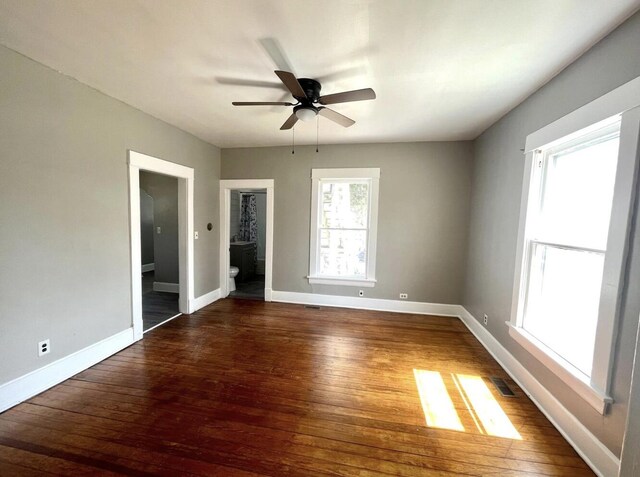 unfurnished room with ceiling fan and dark wood-type flooring