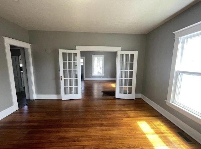 unfurnished room with french doors and hardwood / wood-style flooring