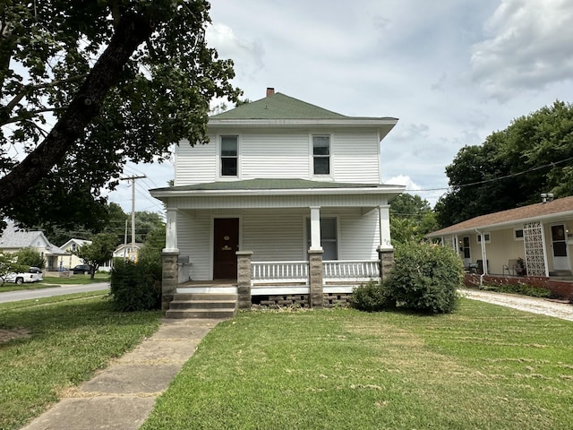 view of front facade with a porch and a front yard