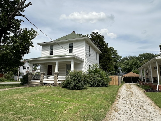 view of front of home featuring a front yard and covered porch