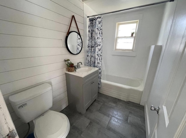 full bathroom featuring wooden walls, vanity, shower / bath combo with shower curtain, and toilet