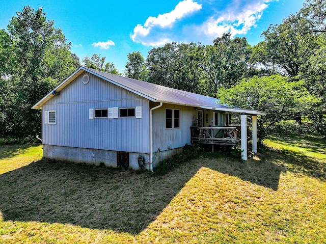 view of side of property with a lawn