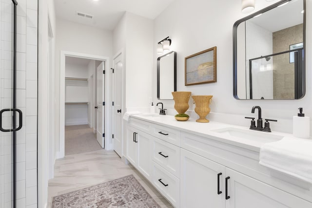 bathroom with vanity and a shower with door