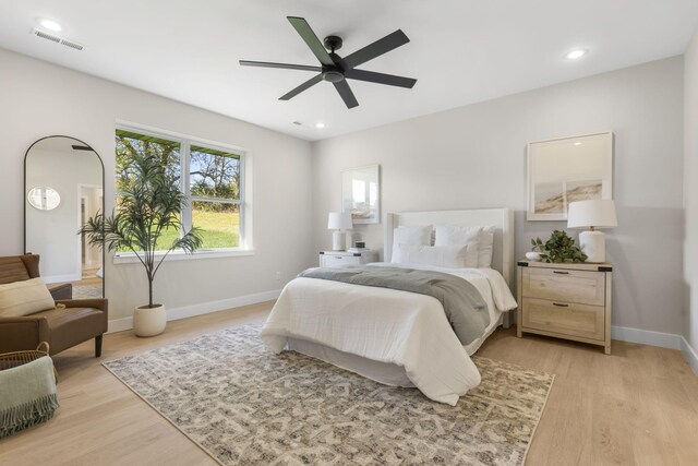 bedroom with ceiling fan and light hardwood / wood-style flooring