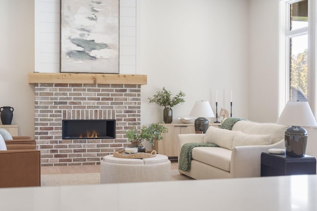 living room featuring a brick fireplace