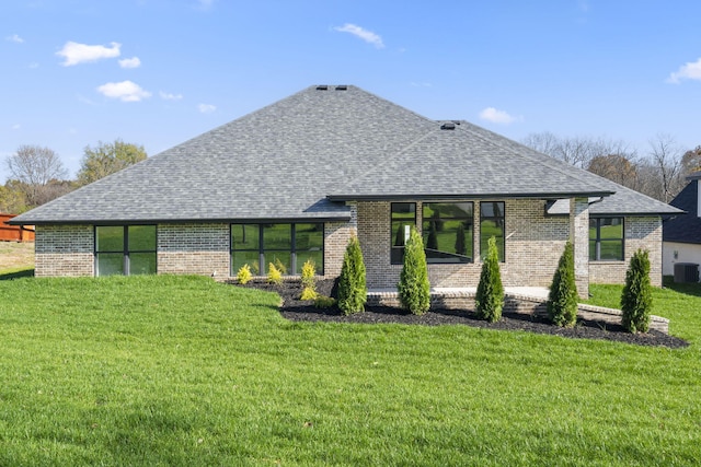 rear view of house with a yard