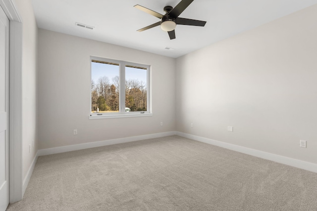 carpeted empty room featuring ceiling fan