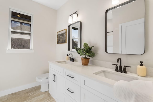 bathroom with toilet and vanity