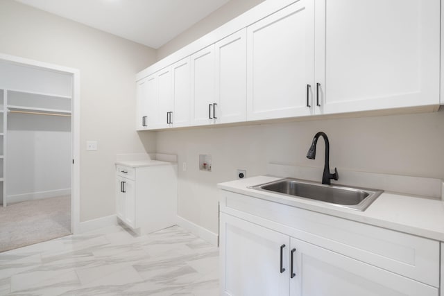 laundry room with cabinets, washer hookup, hookup for an electric dryer, and sink