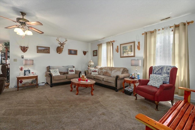 carpeted living room with a wealth of natural light and ceiling fan