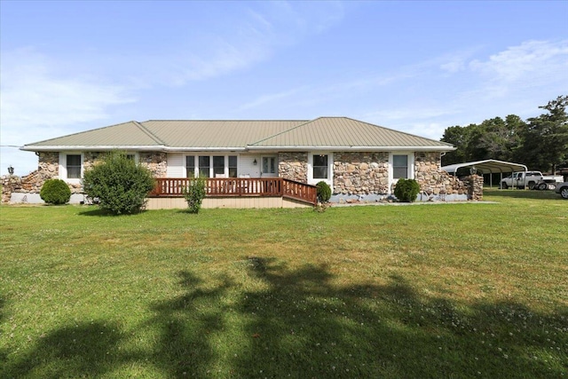 ranch-style house featuring a wooden deck, a carport, and a front yard