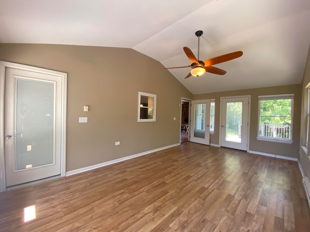 unfurnished living room with wood-type flooring, vaulted ceiling, and ceiling fan