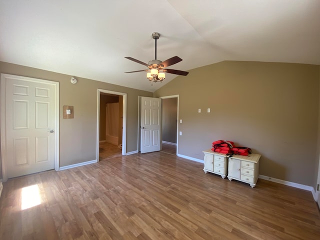 unfurnished bedroom featuring ceiling fan, hardwood / wood-style flooring, and vaulted ceiling